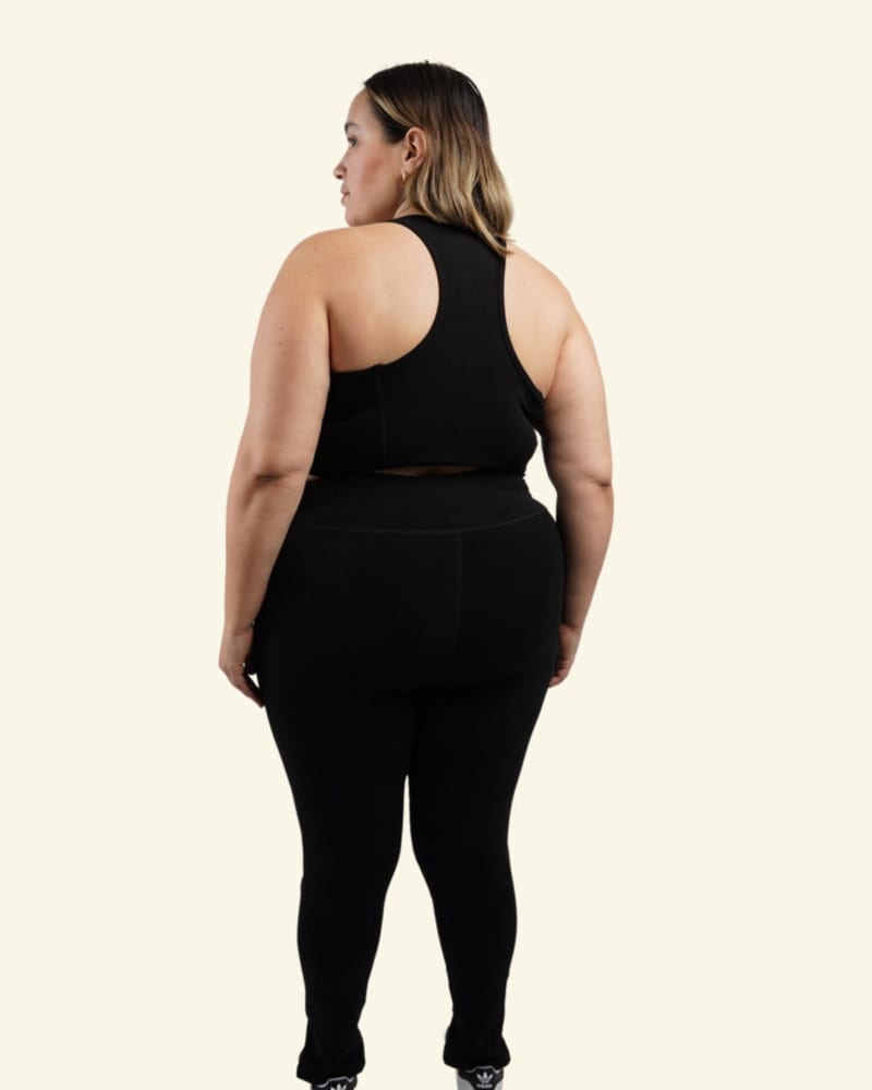 Back of a model wearing a size 6X Aspen Sports Bra in Black by Reprise Activewear. | dia_product_style_image_id:254127